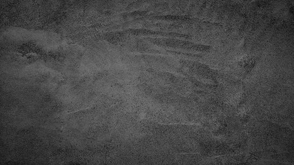A black and white photo of a wall with a grey background. The wall has a few scratches and marks on it, giving it a worn and aged appearance