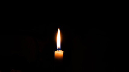 a candle burning with dark background