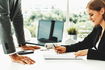 Architect and engineer working with construction drawing project on table in office. Architecture...