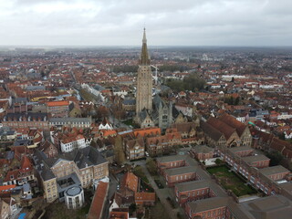 Naklejka premium Brugge from an aerial perspective, highlighting its historical charm, architectural beauty, and scenic waterways 