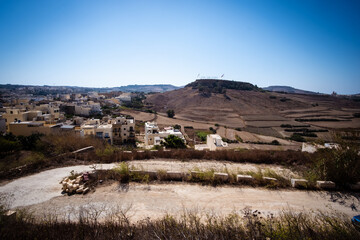 Barren landscape with cranes building new holidays apartments in Gozo, Malta