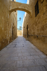 Fototapeta premium Old town medieval village with narrow cobble stone streets in Gozo, Malta Island