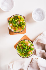 Trendy refreshing iced latte with green onions in glasses on the table top and vertical view