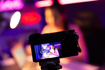 Selective focus camera screen in host channel of beautiful Asian listening the music on social...