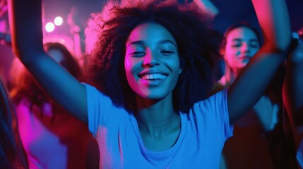 Obraz premium Young woman dancing joyfully at a vibrant party in colorful lights