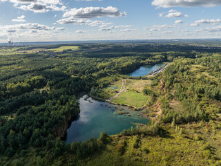 Aerial drone photo of Quarry turquiose lake colour, open pit mining in Park Grodek, Jaworzno. Poland. Turquiose Water and Wooden Bridge on lake. Polish Maldives Park Grodek in Jaworzno from drone.