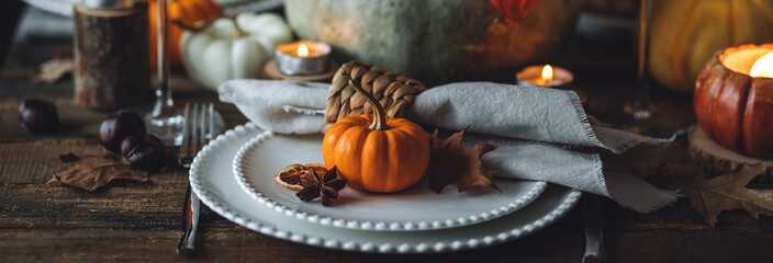 Fall table decoration with pumpkins, wine. Family cozy thanksgiving dinner arrangement indoors at home, wedding elegant decor. Countryside style, simple handmade setting, autumn mood banner