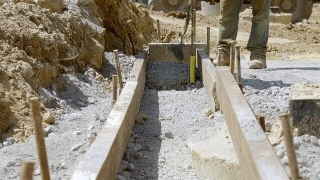 Construction Crew Lays Foundation in a Busy Building Site With Precision