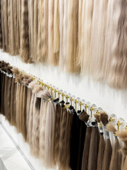 Diverse hair extensions display in soft blonde and brown tones