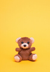 Teddy bear on a yellow
