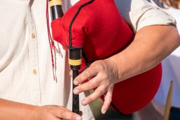 Hands of a musician playing a bagpipe in Galicia, Spain. Folk music concept