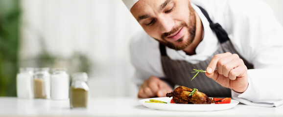 Cook Man Decorating Chicken Dish Preparing Dinner In Restaurant Kitchen Indoor. Cropped, Selective Focus