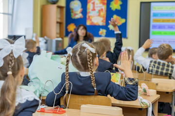 Russia. Saint-Petersburg. School children are stretching their arms in the classroom.
