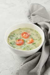 Typical Portuguese soup Caldo Verde on gray background close up