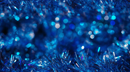 Fototapeta premium shimmering tinsel garland texture with a blend of metallic deep blue, turquoise and silver strands