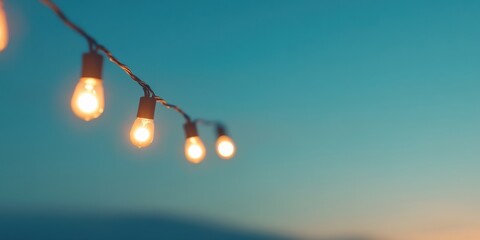 String lights softly glowing against the serene backdrop of a dusk sky, creating a peaceful and soothing ambiance perfect for evening settings and outdoor decor.
