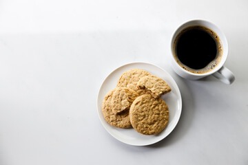 Cup of black coffee, Cookies on white marble background. Copy space. Flat lay. Top view.