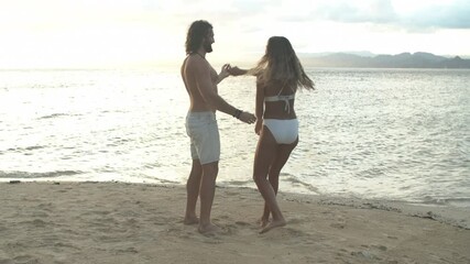 Happy couple, dance and beach for love, care or embrace on holiday vacation, weekend or tropical getaway. Woman or man enjoying fun ocean coast in romantic sunset or outdoor bonding together by water