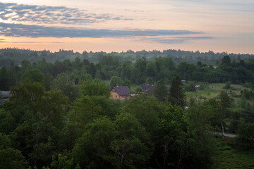 Fototapeta premium View of the Izborsko-Malskaya Valley and the village of Izborsk on a summer morning, Pechersk district, Pskov region, Russia