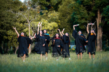 A group of women in graduation gowns are celebrating their achievements by throw