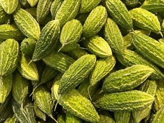 Top view of a group of green bitter melon or bitter gourd sale at the groceries market in Malaysia.
