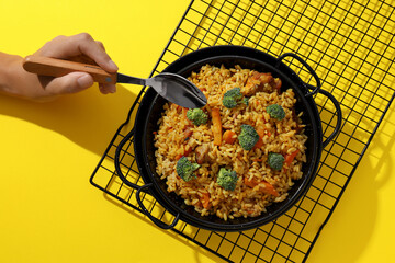 A tart with pilaf, on a yellow background.
