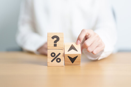 wood block of Question mark with percentage change to UP and Down arrow. Interest rate, GDP, stocks market, financial, deflation and Inflation, ranking, mortgage, debt, Loan and Economic Recession