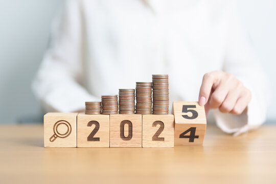 2024 end year to Happy New Year 2025 with  coins money stack growing with magnifier glass. Money saving, Inflation, tax, cash flow, Job search, hiring and research development concepts