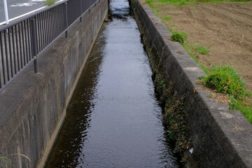 Obraz premium Irrigation canal along the road in Japan