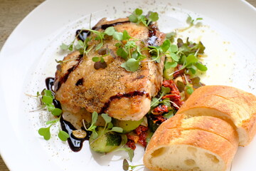 Chicken steak with roasted cucumber, nuts and anchovies