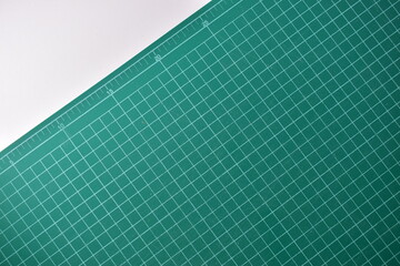 green cutting mat board on white background with line and scale measure guide pattern for object art design, tool equipment of diy craft work
