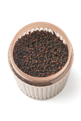 bucket full of dry cloves isolated white background, strong spicy flavor buds used in culinary and traditional medicine, most valued spice native to tropical region
