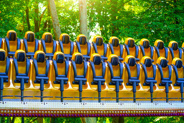 Empty yellow row seats, extreme amusement park attraction rotation in a circle vertically, test...