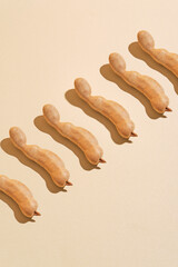 Patterned beige background with tamarine; perfect for organic, natural, earthy designs like packaging, stationery, or digital backgrounds.