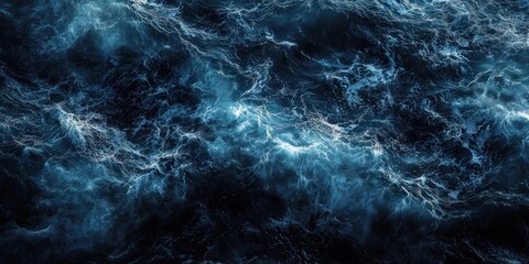 Top view of dark blue ocean wave surface, swirling, abstract.
