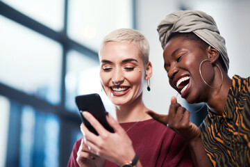 Business, women and laughing at phone in office for social media meme, internet joke or funny text message. Creative designer, team and comedy video on smartphone with streaming service or online app