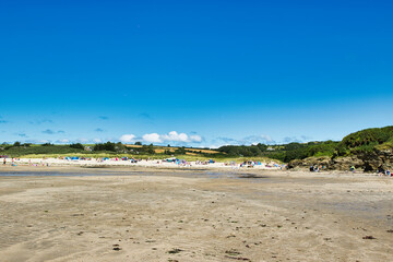 Sunny Beach Day with Colorful Umbrellas in Cornwall, UK