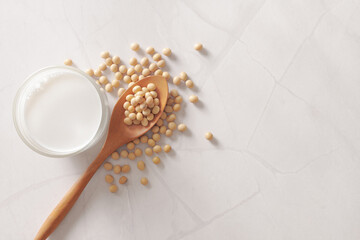Soy milk and soybeans on marble background. 