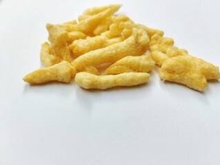 yellow crunchy corn chips with a sweet and savory taste on a white background.
