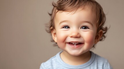 Naklejka premium A baby with blond hair and big blue eyes smiles happily.