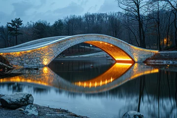 A bridge spans a body of water, with a reflection of the bridge in the water