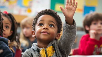 A young boy is raising his hand in a classroom