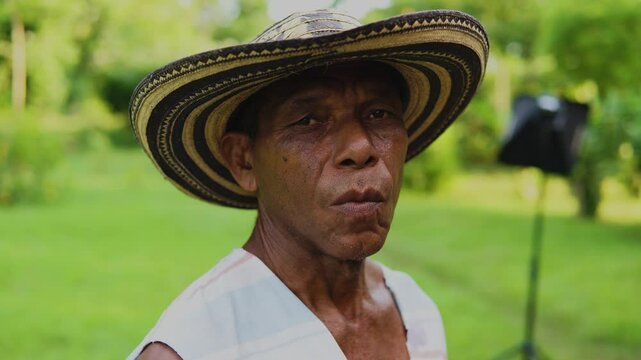 Campesino o trabajador del campo de la costa colombiana, cultivador de mata de yuca, tuberculo o raiz.  vestimenta de finca o campo con sombrero vueltiao, con machete, botas pantaneras y perro fiel.