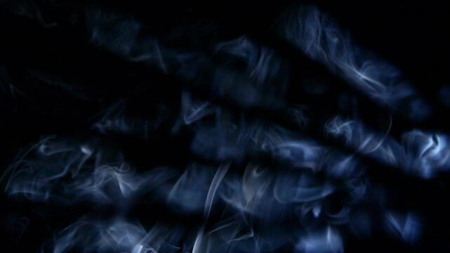 Abstract blue clouds of smoke, fog, steam, mist texture on black in slow motion