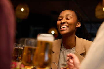 Caucasian and African colleagues eating and drinking together