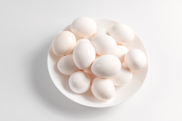 White eggs on a white plate.