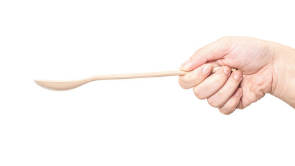Female hand holding a brown plastic spoon isolated on white background.