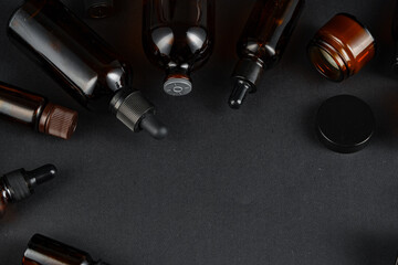 Various glass bottles arranged on a dark surface