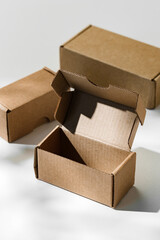 Open cardboard box on a reflective surface with soft shadows