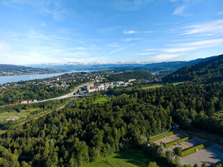 Aerial view from Swiss City of Zürich with woodland and Lake Zurich with horizon in the background on a sunny late summer afternoon. Photo taken September 6th, 2024, Zurich, Switzerland.